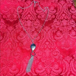 Silver-tone pendant w/chain tassel drop. Etched silver tone/or white